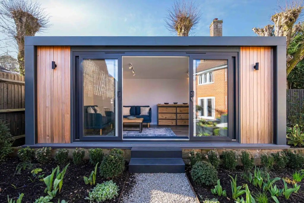 Modern garden room with sliding glass doors and stylish interior design in UK garden setting